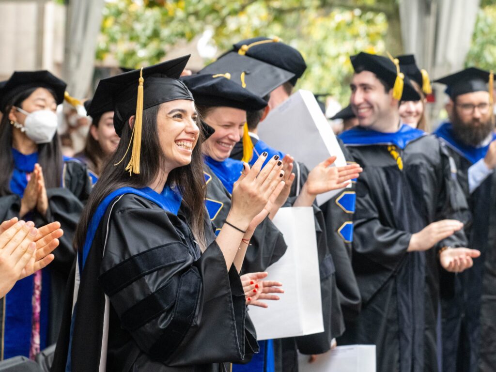 Doctoral graduates cheer during the Class of 2020 commencement ceremony