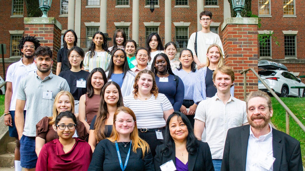 A group of students and faculty from the Biochemistry & Molecular Biology program pose on the Med-Dent Steps during Fall 2024 Orientation.