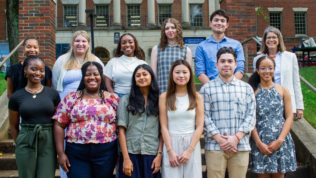 A group of students and faculty from the Integrative Medicine & Health Sciences program pose on the Med-Dent Steps during Fall 2024 Orientation.