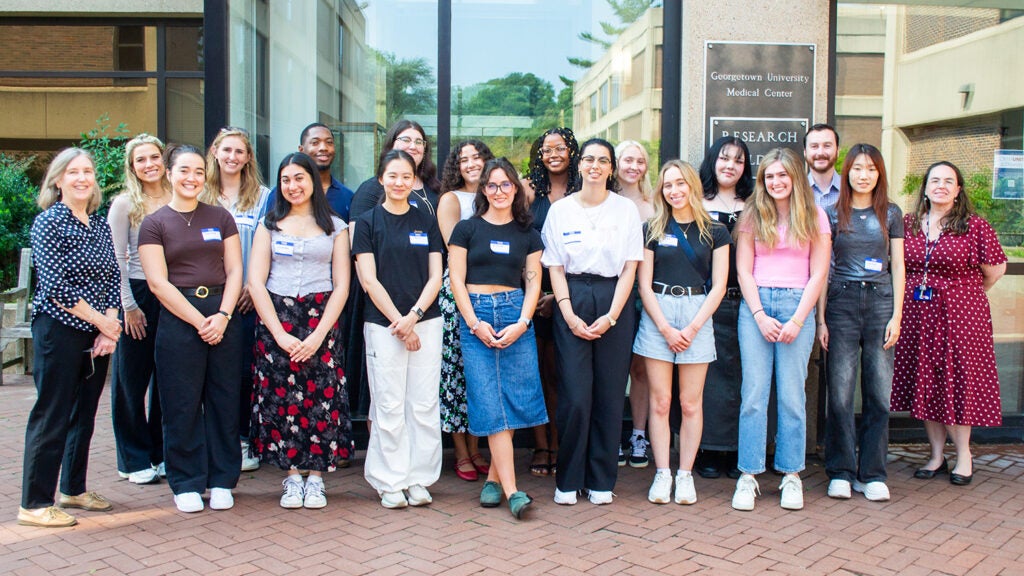 A group of students and faculty from the Integrative Neuroscience program pose on the Med-Dent Steps during Fall 2024 Orientation.