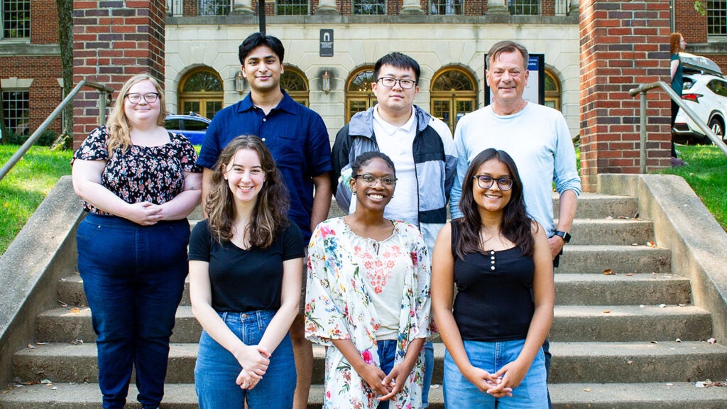 A group of students and faculty from the Microbiology & Immunology program pose on the Med-Dent Steps during Fall 2024 Orientation.