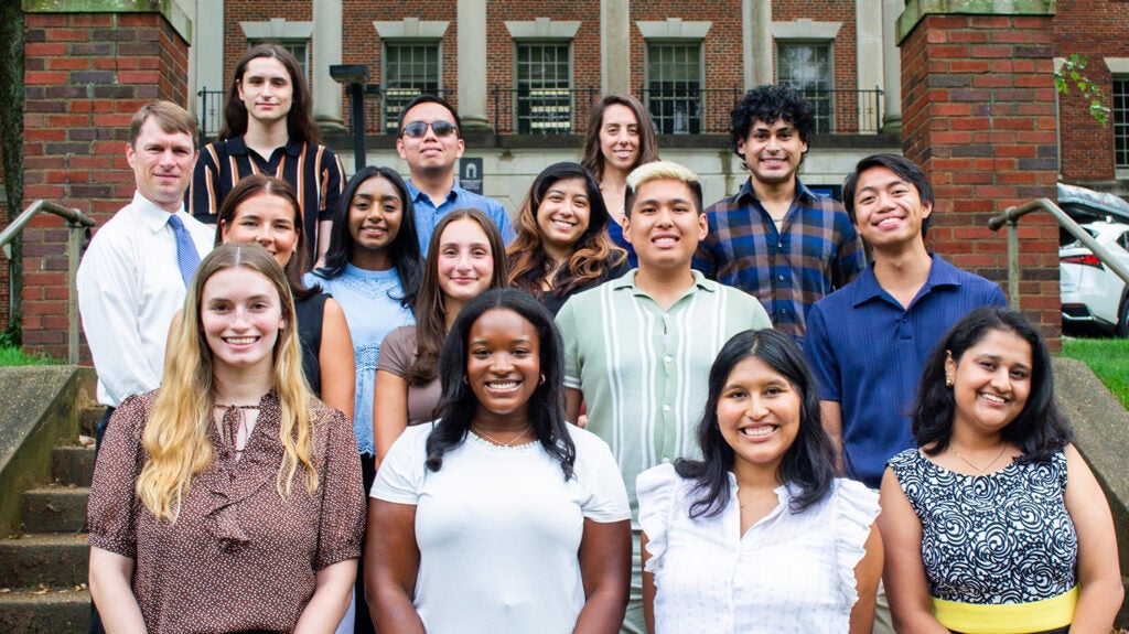 A group of students and faculty from the Pharmacology program pose on the Med-Dent Steps during Fall 2024 Orientation.