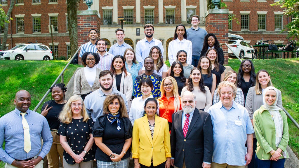 A group of students and faculty from the Systems Medicine program pose on the Med-Dent Steps during Fall 2024 Orientation.