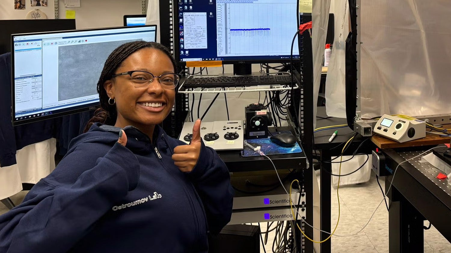 Gabbi Williams smiles in front of a computer in the lab.