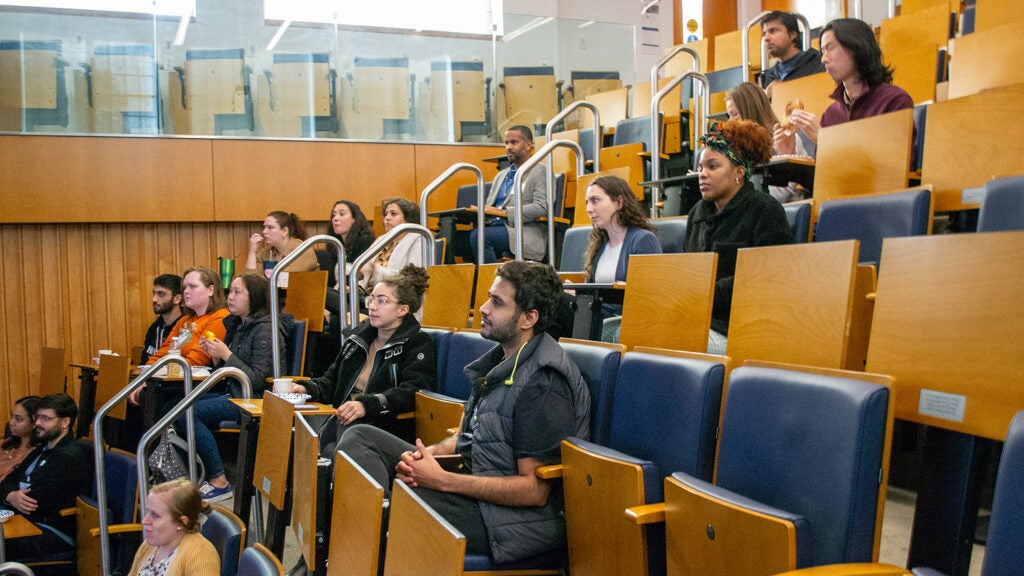 Students listen to Ukpong Eyo's keynote presentation on his microglia research.