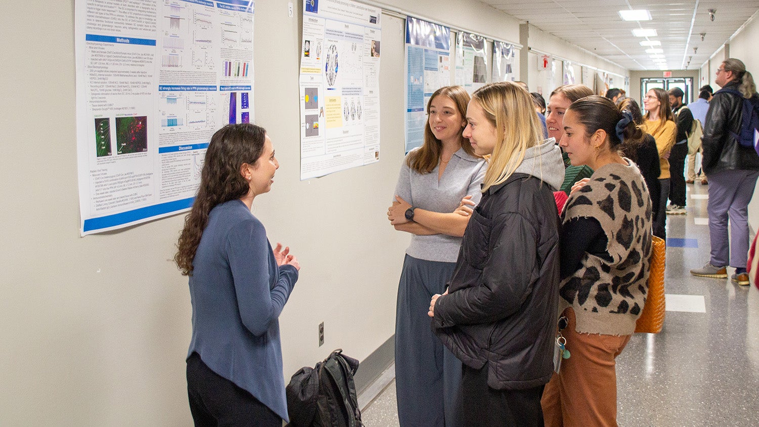 Attendees listen to Briana Bernstein, a student in the Interdisciplinary Program in Neuroscience, during poster presentations.