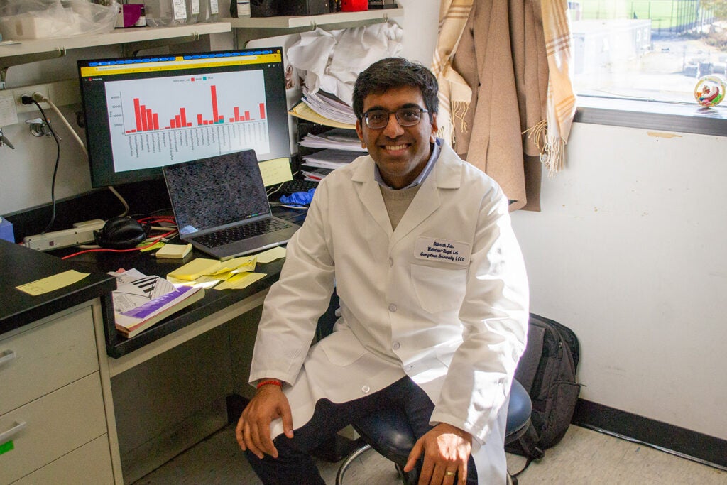 Tumor Biology M.D./Ph.D. student Sidharth Jain poses at a workstation in the Wellstein-Riegel Lab