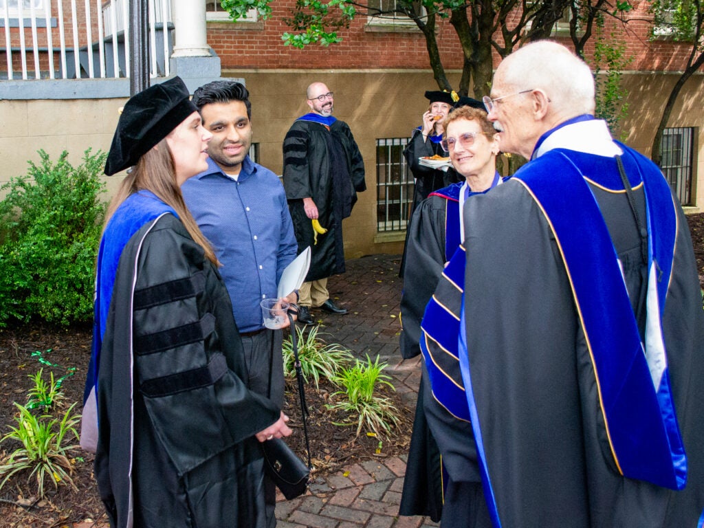 Ph.D. graduate and faculty at the Doctoral Hooding Reception