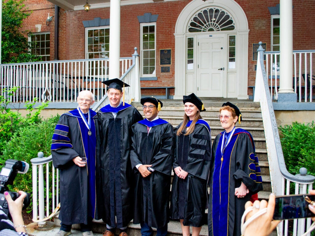 Ph.D. graduates and faculty at the Doctoral Hooding Reception