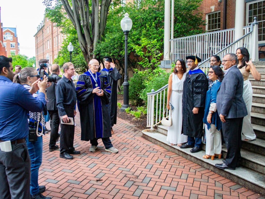 Ph.D. graduates, family and faculty at the Doctoral Hooding Reception