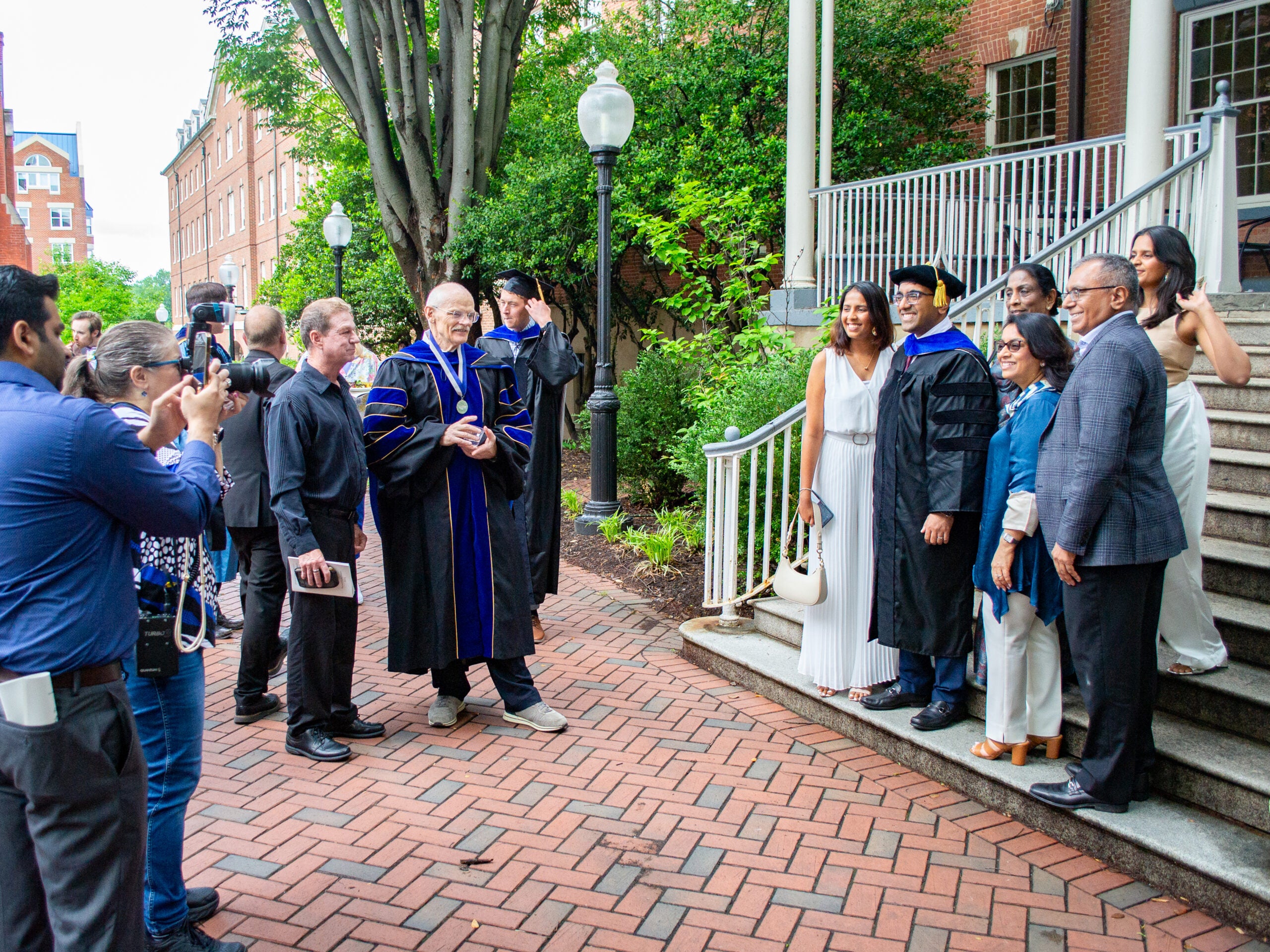 Ph.D. graduates, family and faculty at the Doctoral Hooding Reception