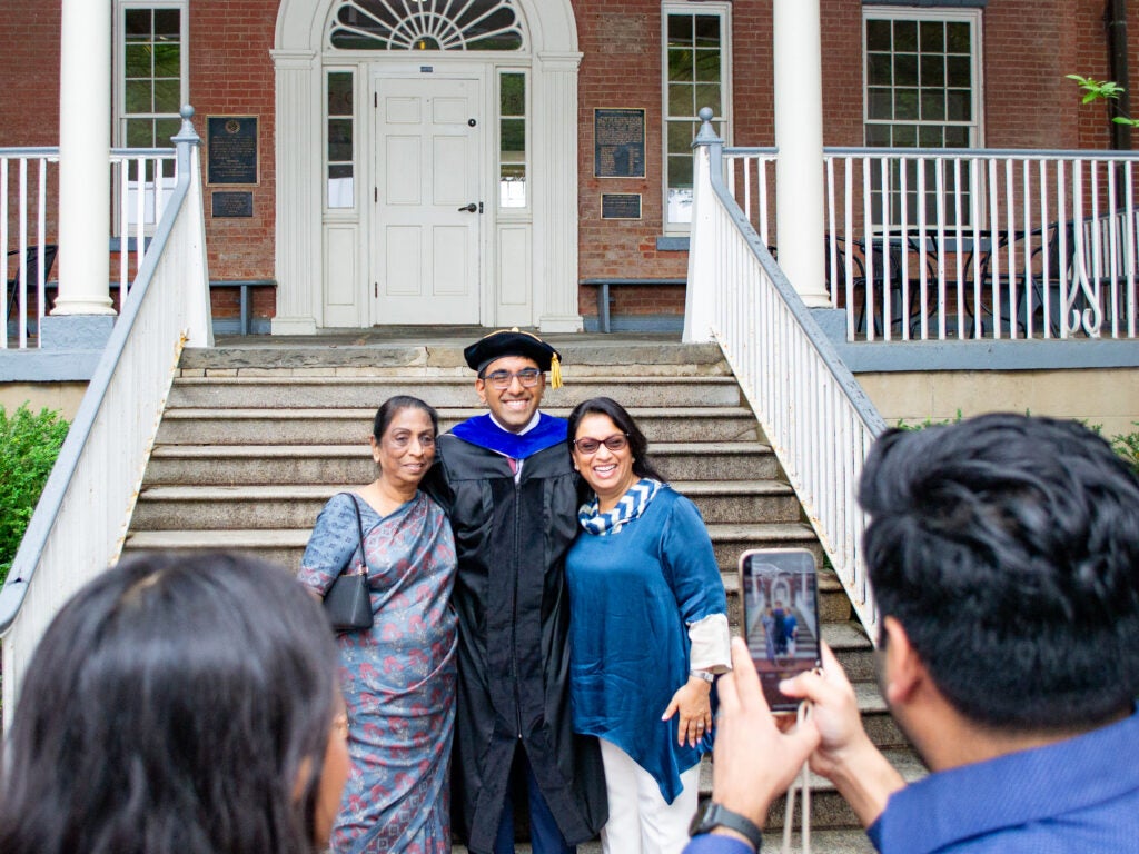 Ph.D. graduate and family at the Doctoral Hooding Reception