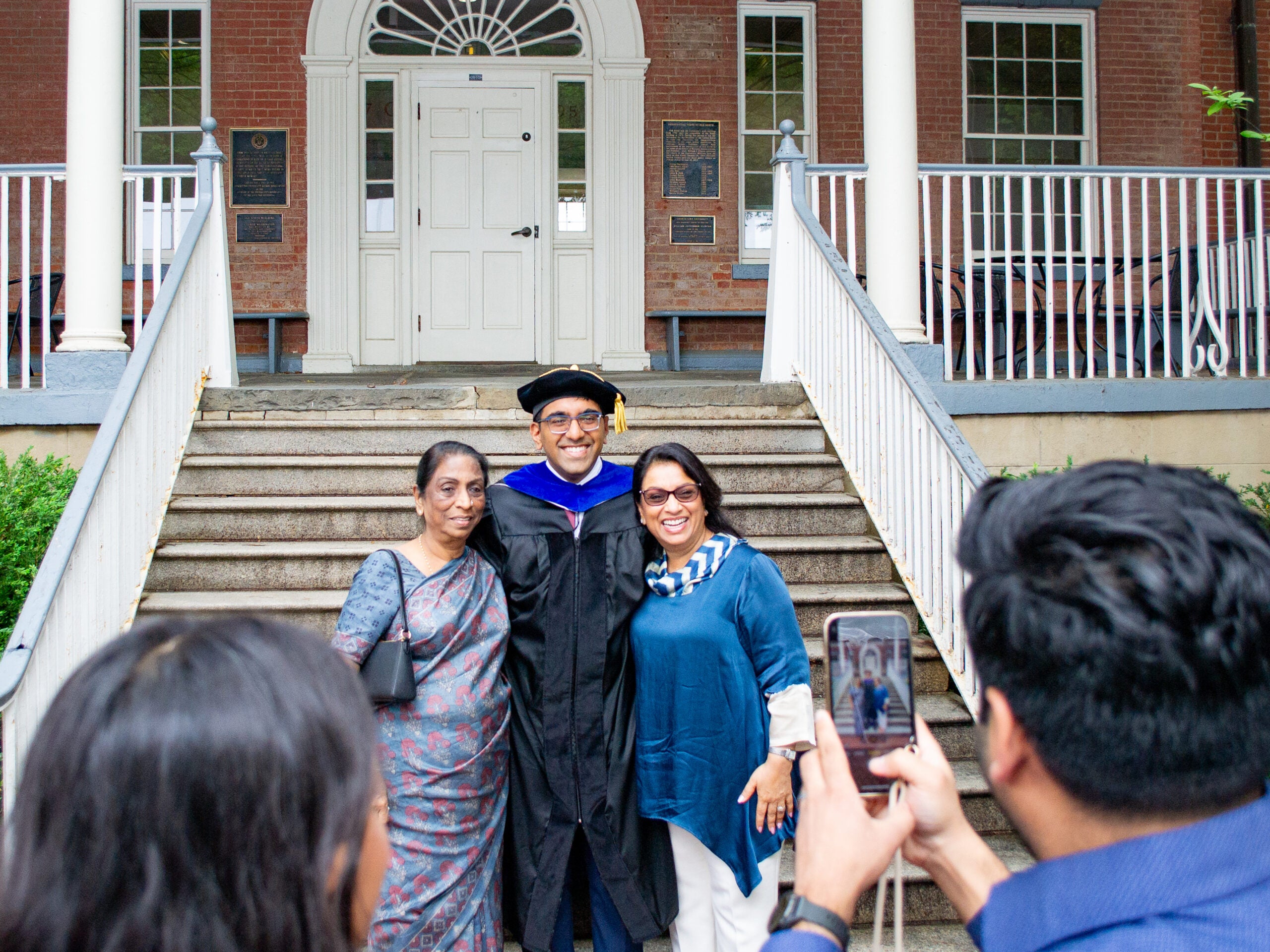 Ph.D. graduate and family at the Doctoral Hooding Reception