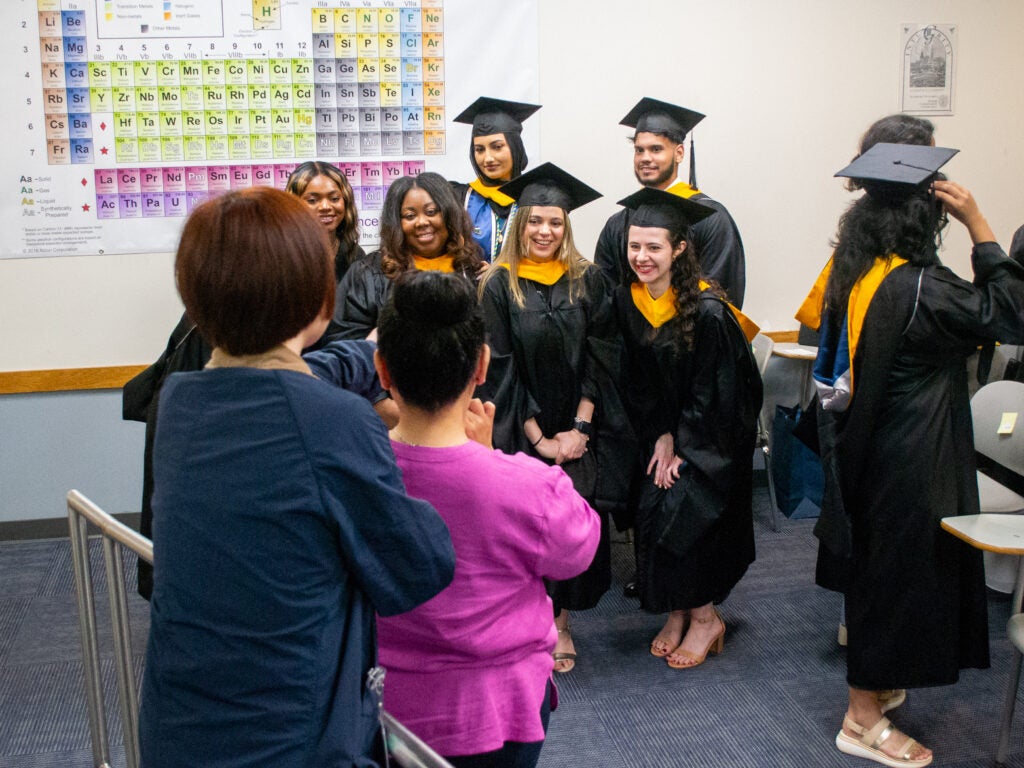 Graduates pose for a photo at Commencement line-up