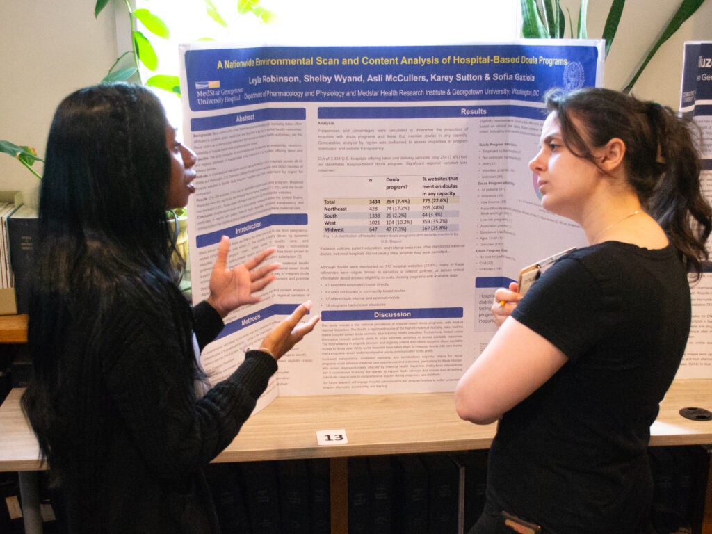 A student presents her research at the Pharmacology and Physiology poster session