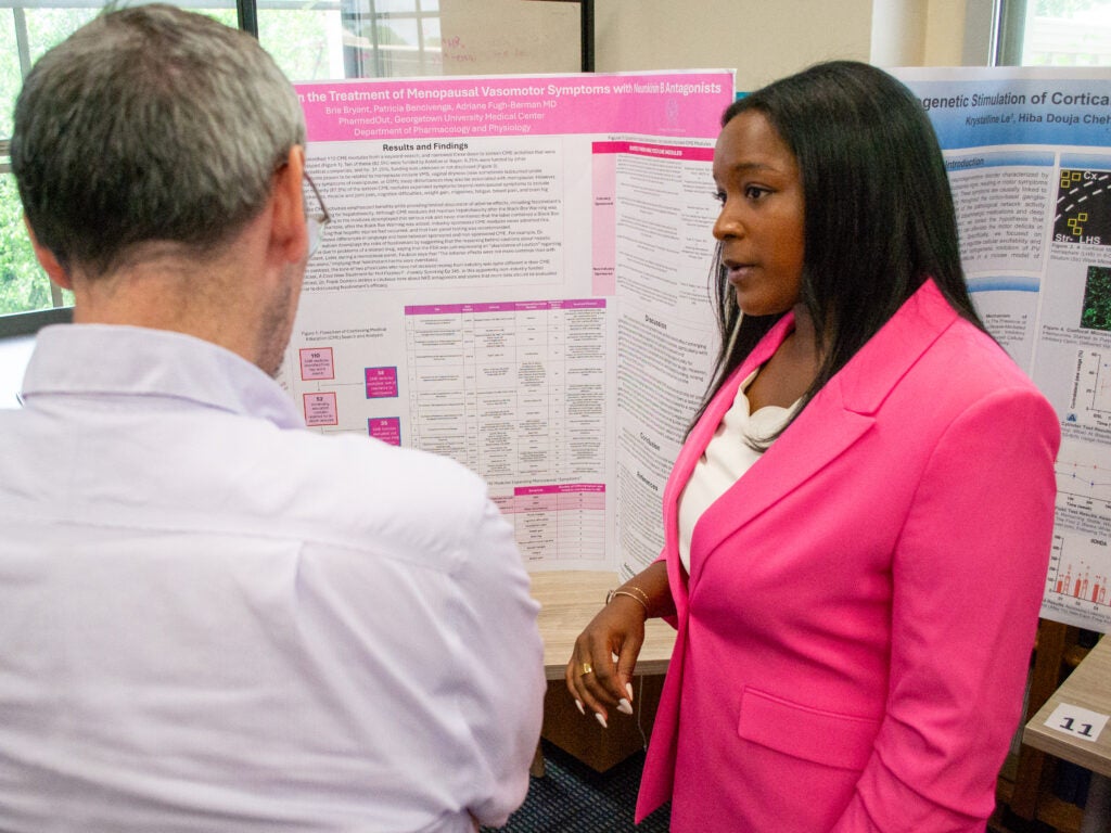 A student presents her research at the Pharmacology and Physiology poster session