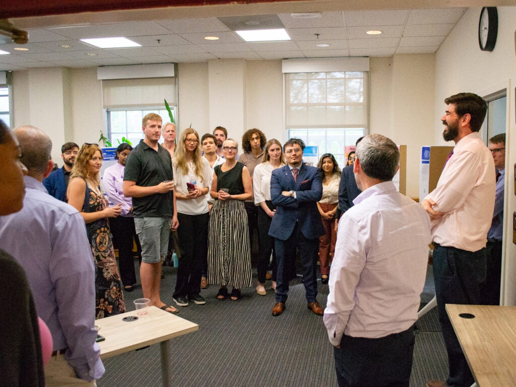 Faculty address attendees at the Pharmacology and Physiology poster session