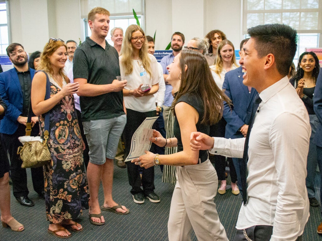 Second-place award winners celebrate at the Pharmacology and Physiology poster session