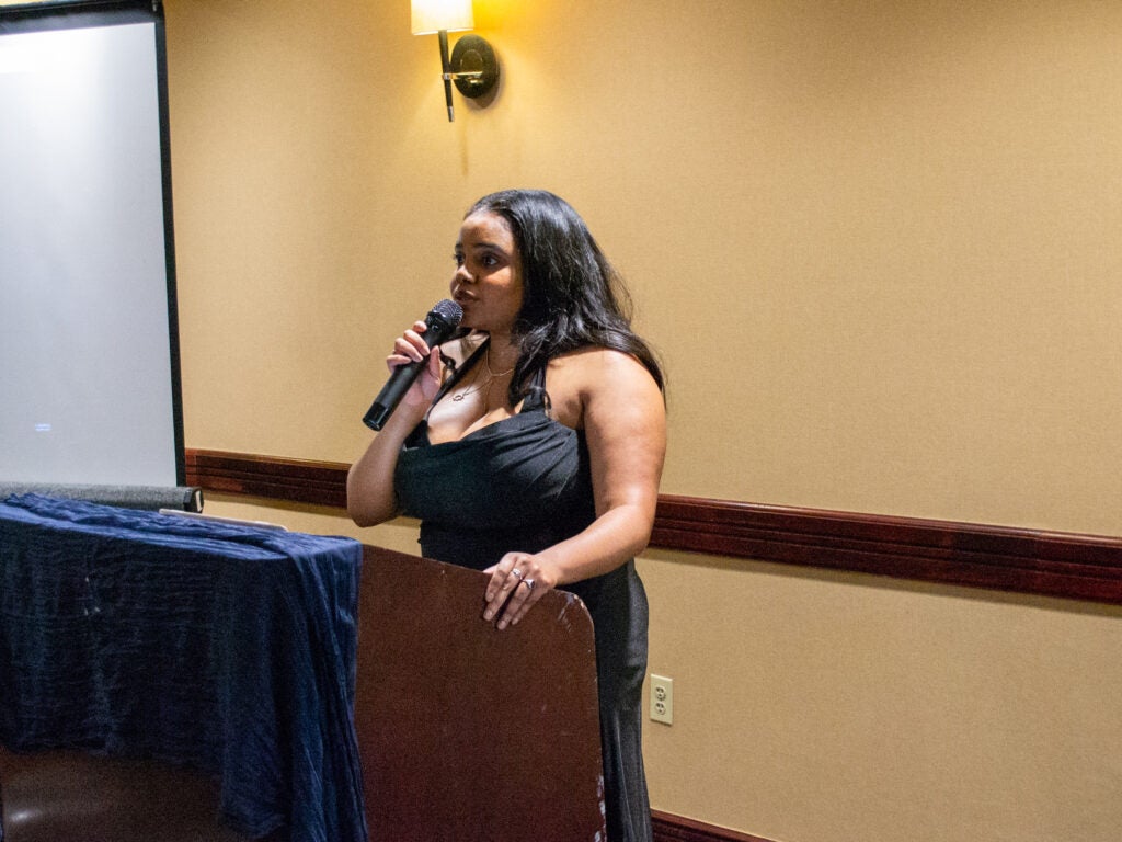A student sings to attendees at the Systems Medicine program gala