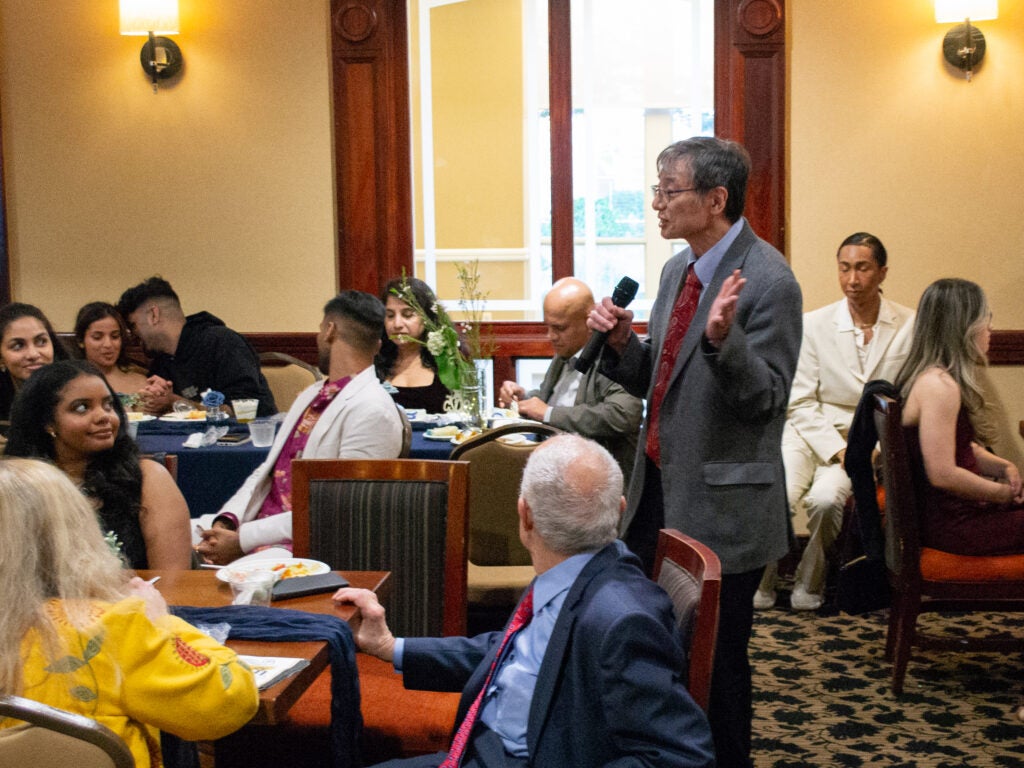 A professor addresses attendees at the Systems Medicine program gala