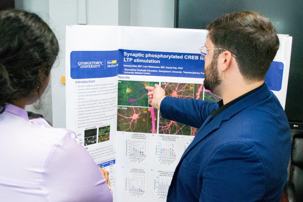 Osmany Diez presents his research during a Pharmacology and Physiology poster session.