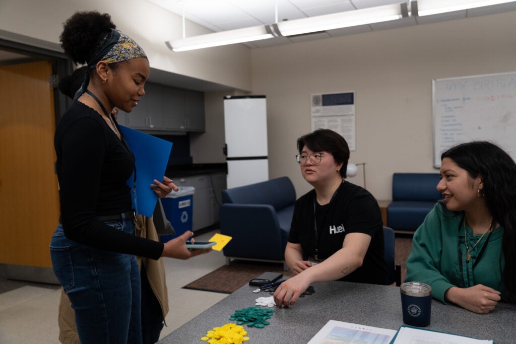 One participant exchanges stamps for money, in the form of poker chips