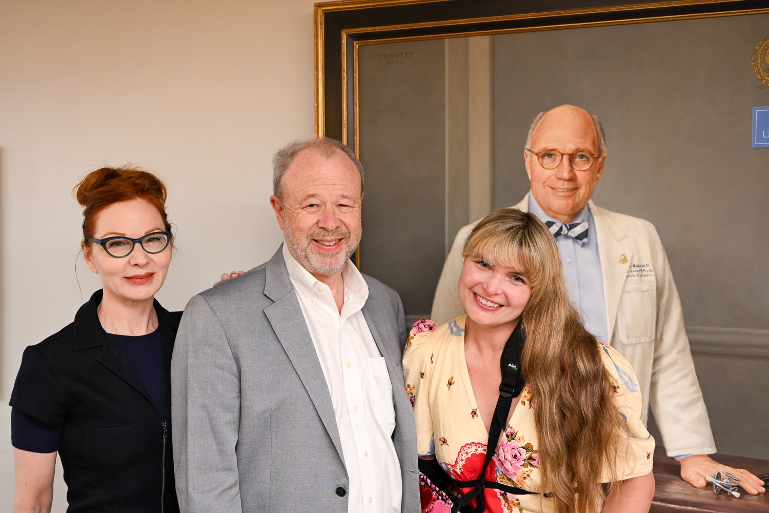 From left: Susan Lynskey, Heart of the Harvey co-founder; neuroscience professor Bill Rebeck, co-founder and co-producer; and performing arts faculty April Brassard, co-producer, stand in front of a painting of former medical dean Stephen Ray Mitchell.