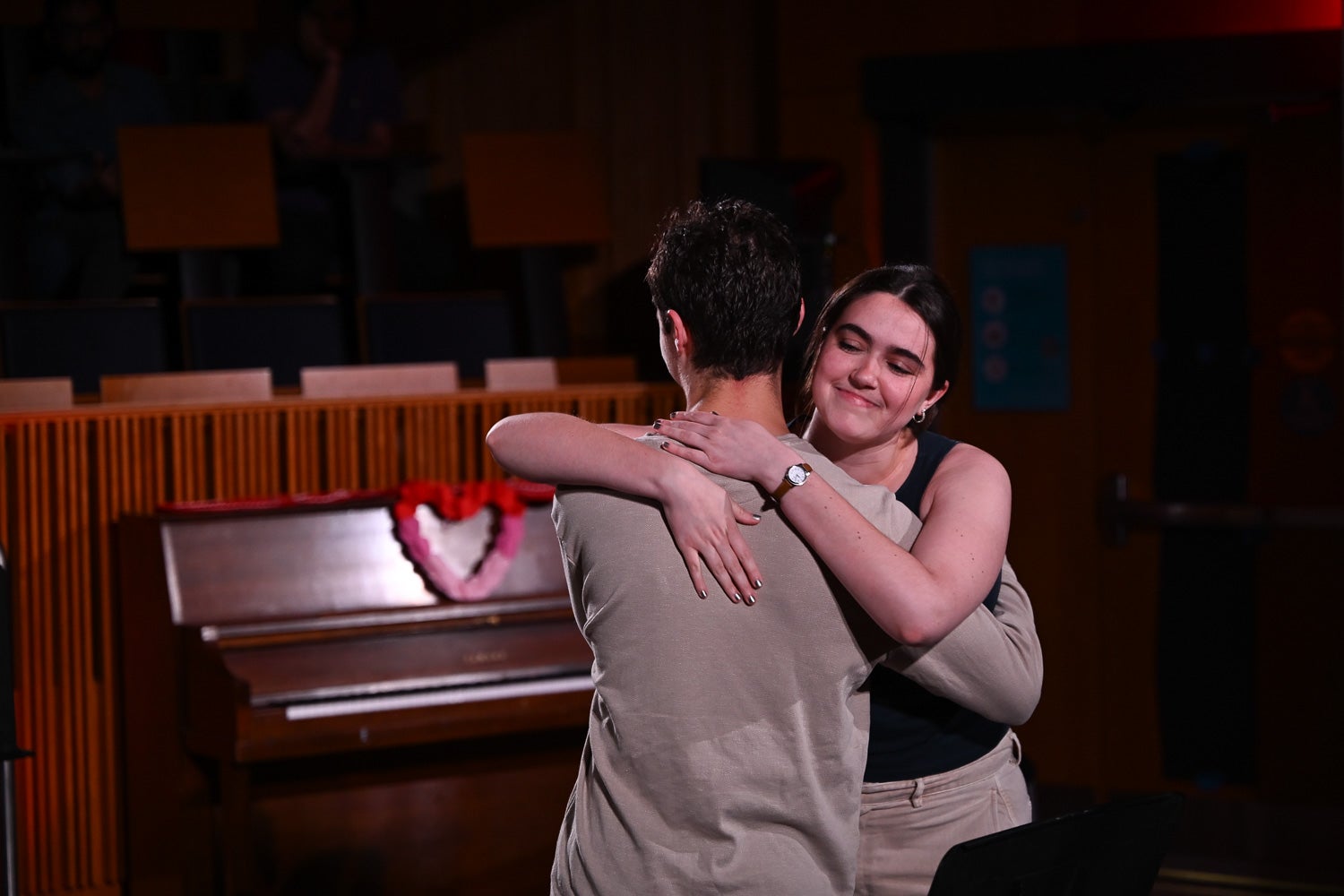Undergraduate students Ben Notaris and Catherine Hughes embrace while acting in