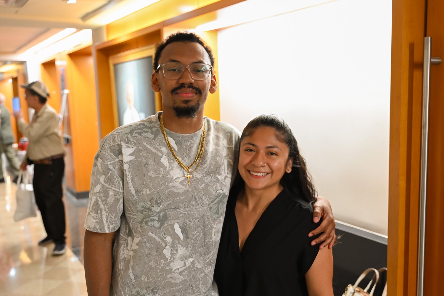 Integrative Medicine & Health Sciences students Kevin Williams and Shannon Miranda pose together in the hallway outside of Harvey Amphitheater