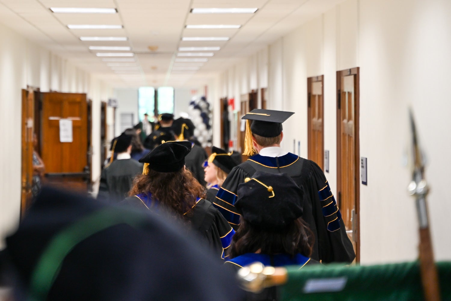 BGE Ph.D. graduates walk out of the line-up room before the School of Medicine Commencement ceremony