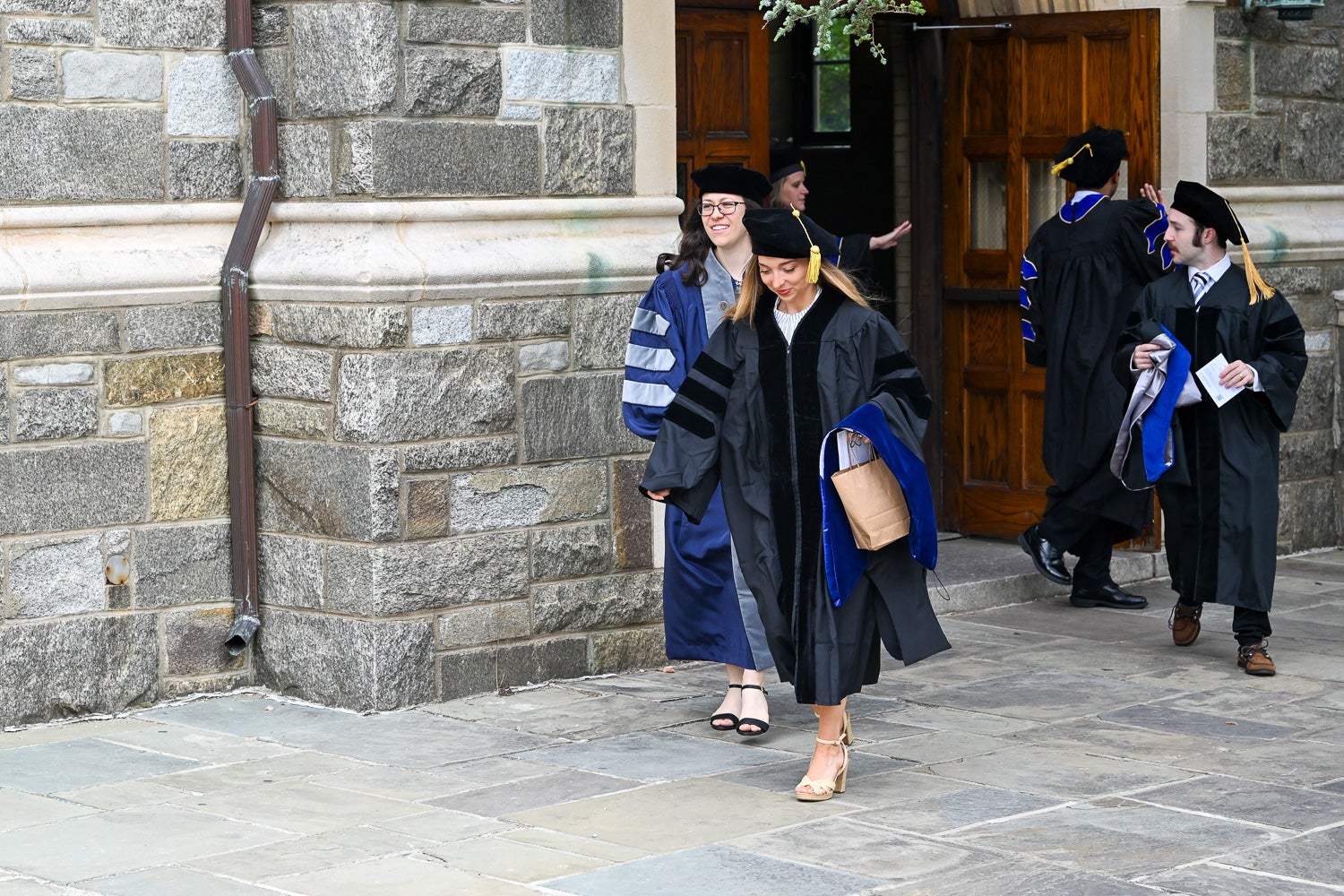 BGE Ph.D. graduates walk on White-Gravenor Esplanade before the School of Medicine Commencement ceremony
