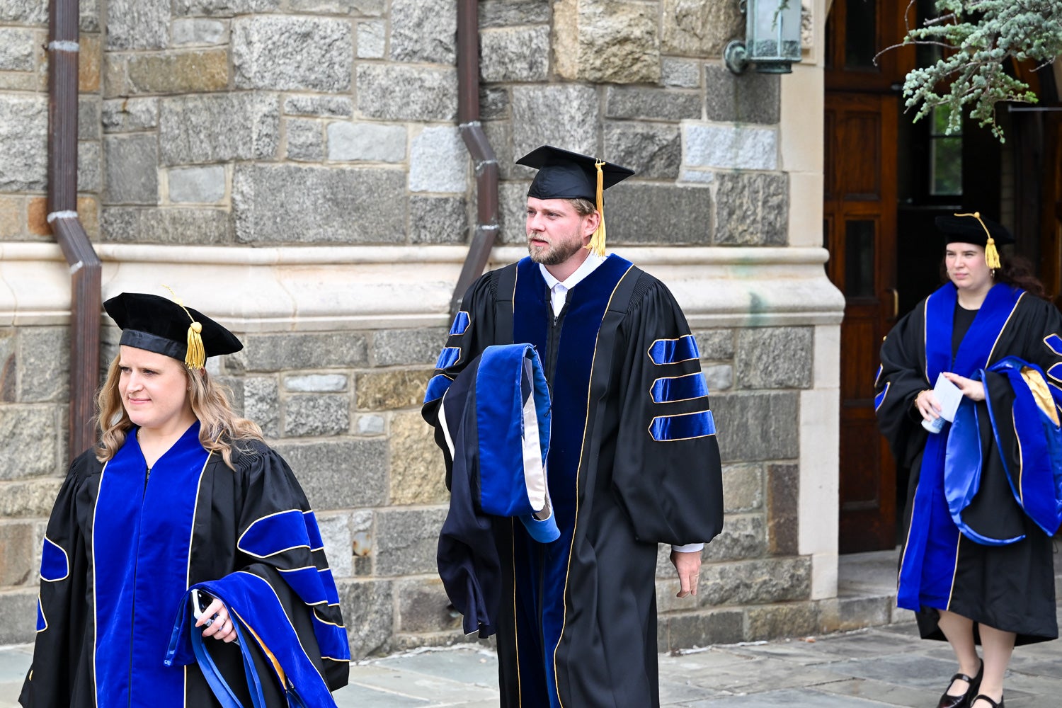 BGE Ph.D. graduates walk on White-Gravenor Esplanade before the School of Medicine Commencement ceremony