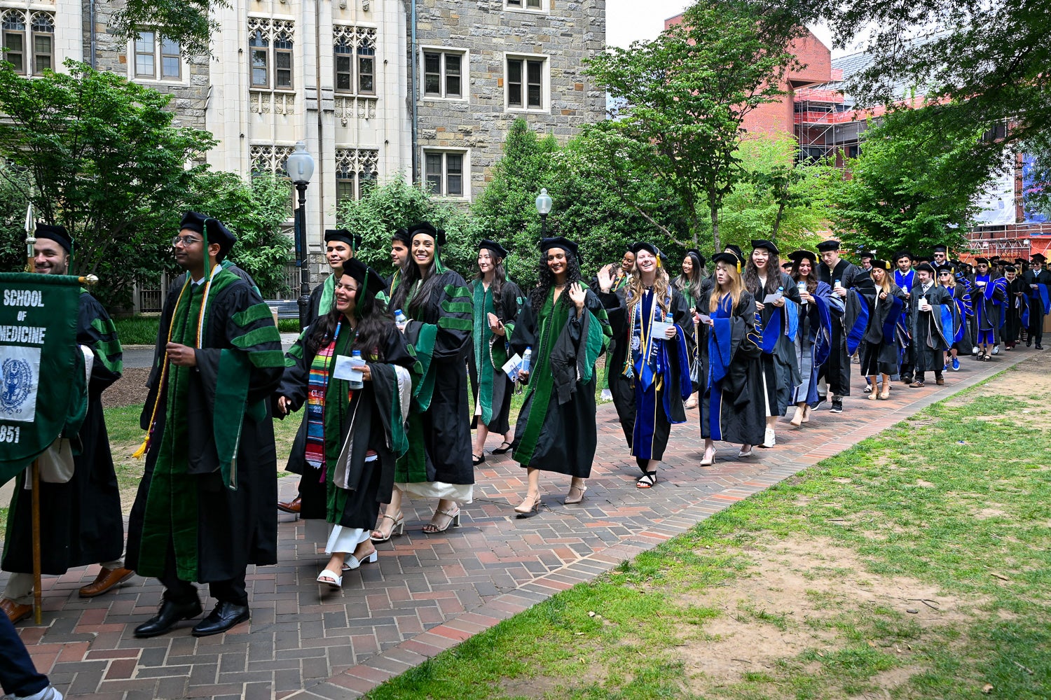 BGE Ph.D. graduates process across Copley Lawn to Healy Lawn for the School of Medicine Commencement ceremony