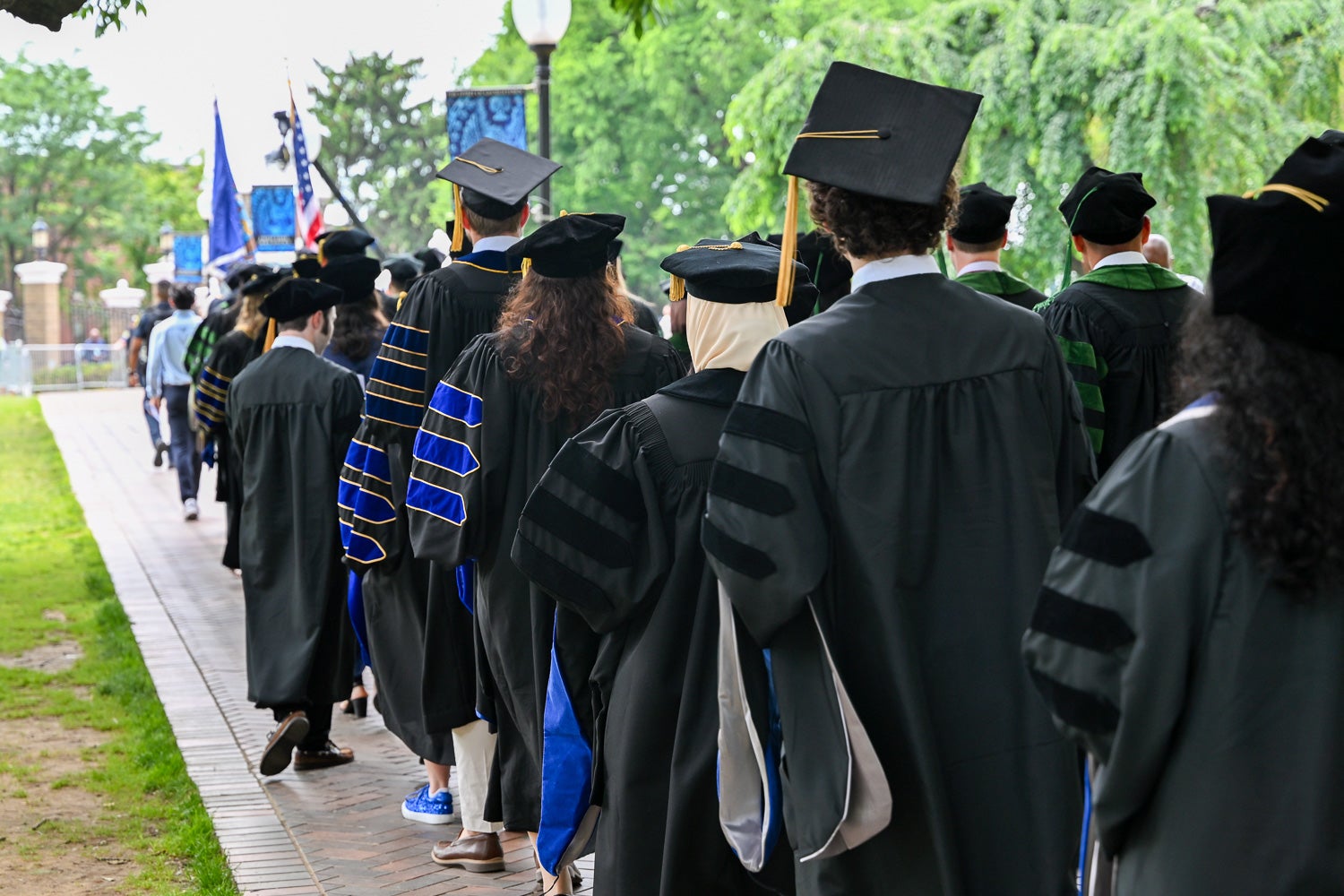 BGE Ph.D. graduates process across Copley Lawn to Healy Lawn for the School of Medicine Commencement ceremony