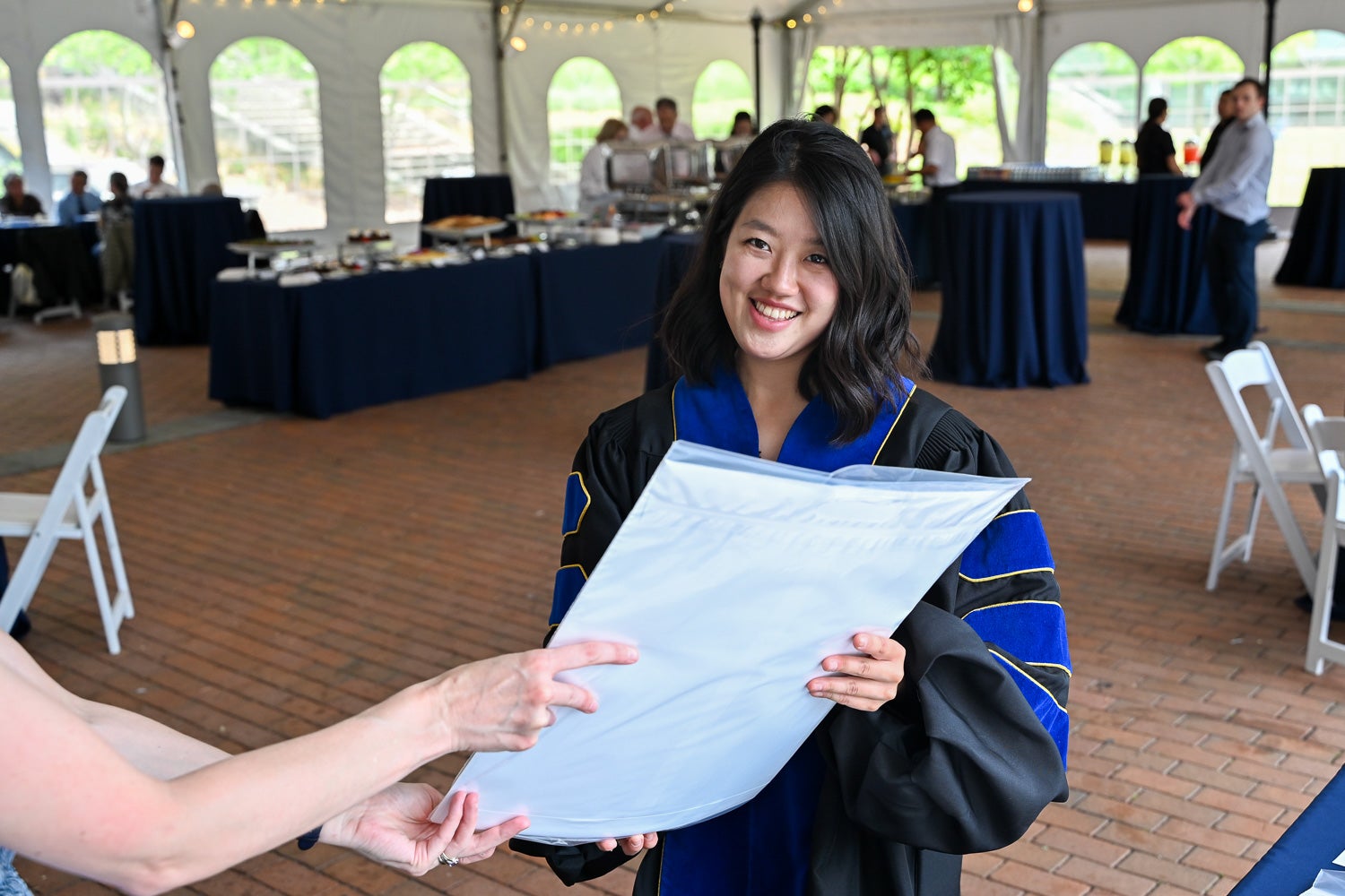 A graduate receives her diploma at the BGE Ph.D. Reception