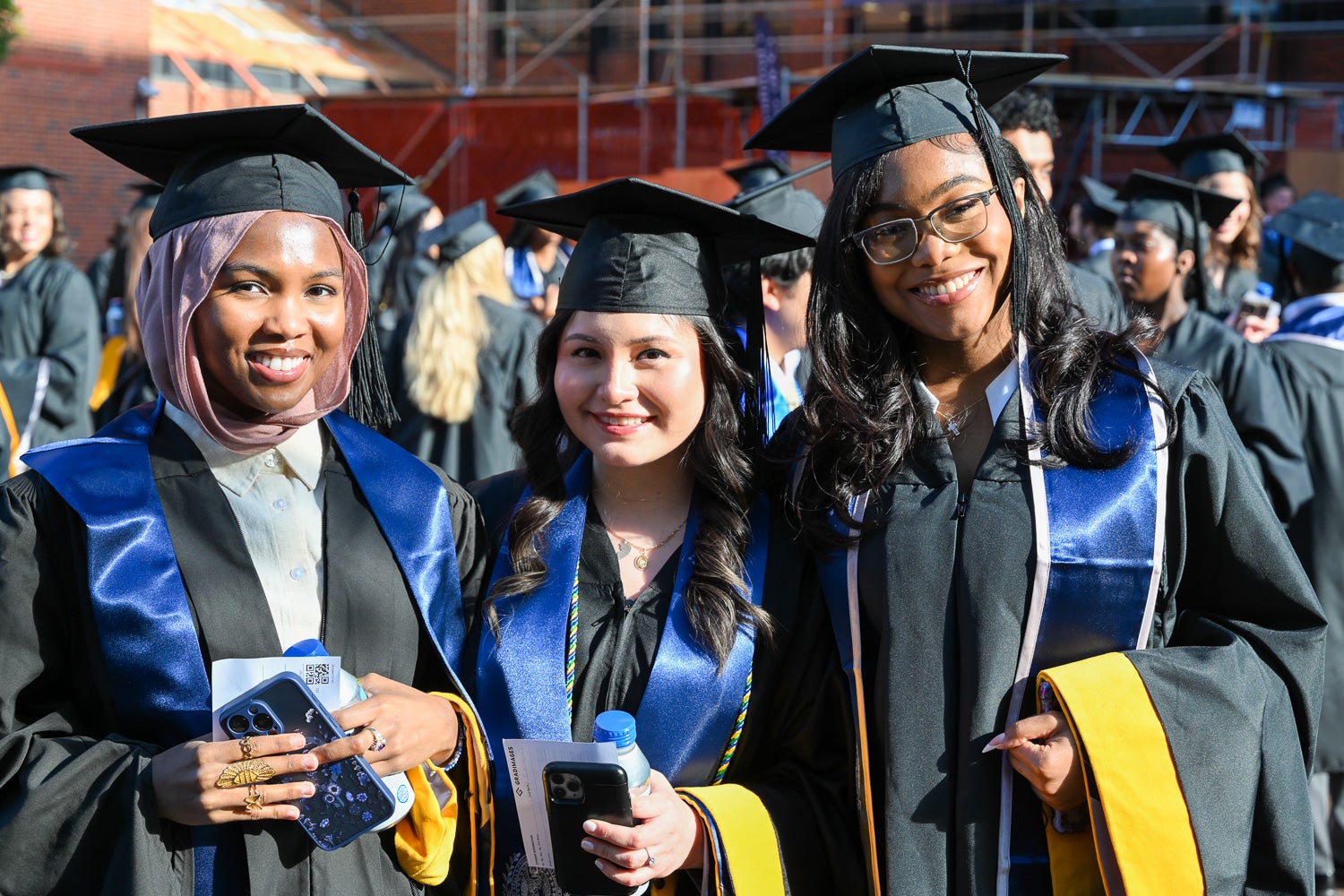 Graduates in commencement regalia pose together on Red Square before the ceremony