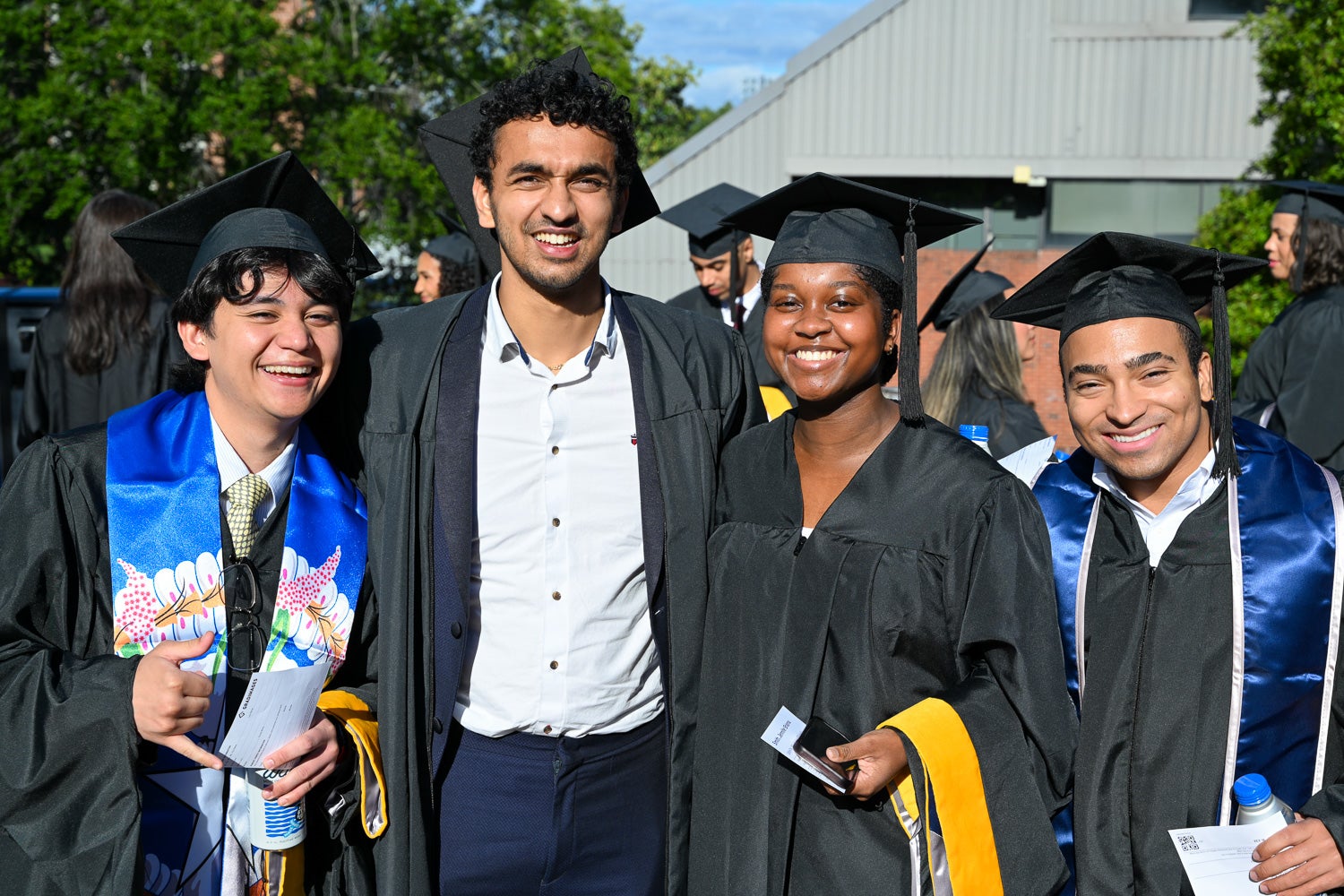 Graduates in commencement regalia pose together on Red Square before the ceremony