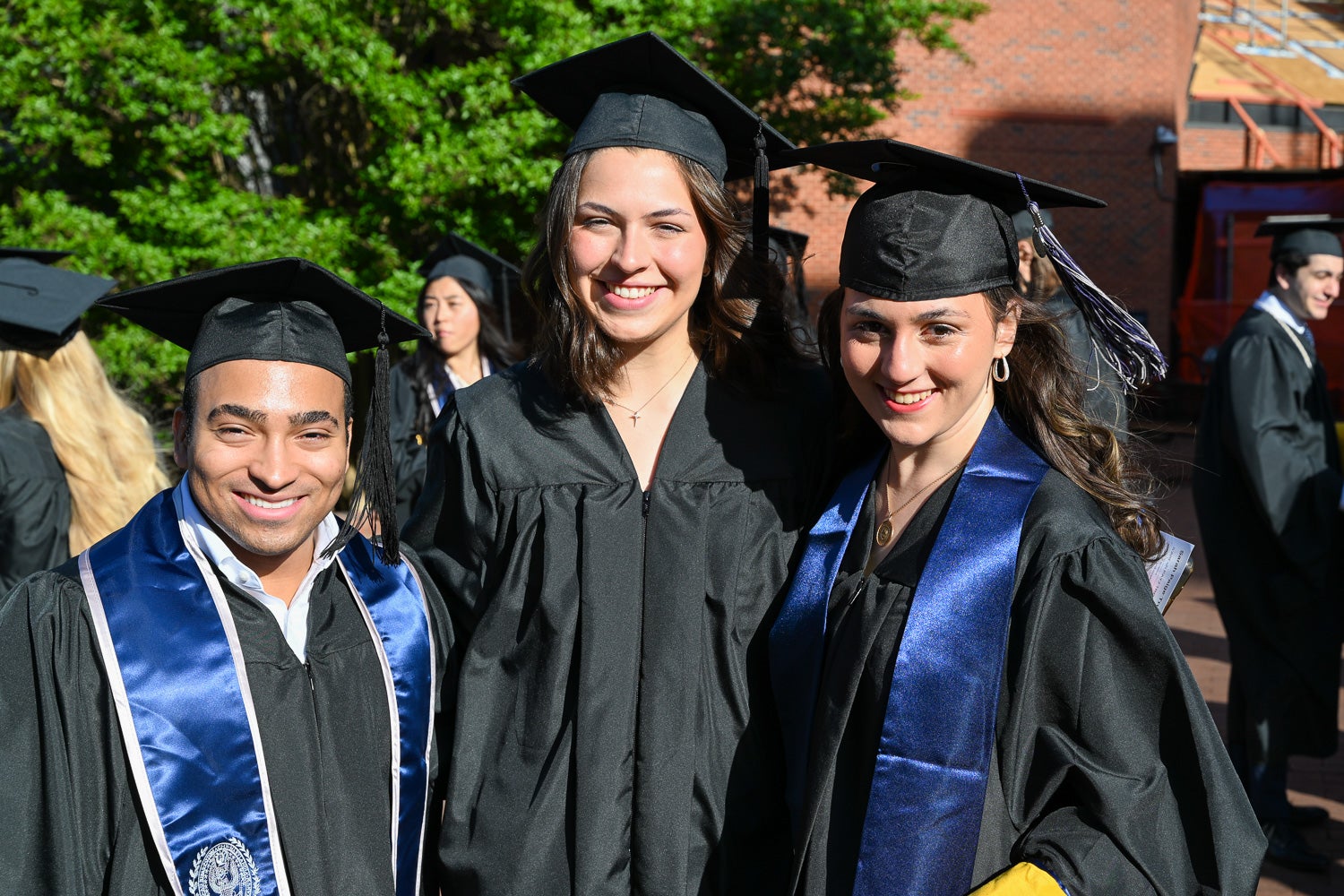 Graduates in commencement regalia pose together on Red Square before the ceremony