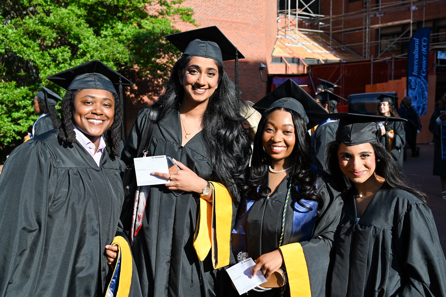 Graduates in commencement regalia pose together on Red Square before the ceremony