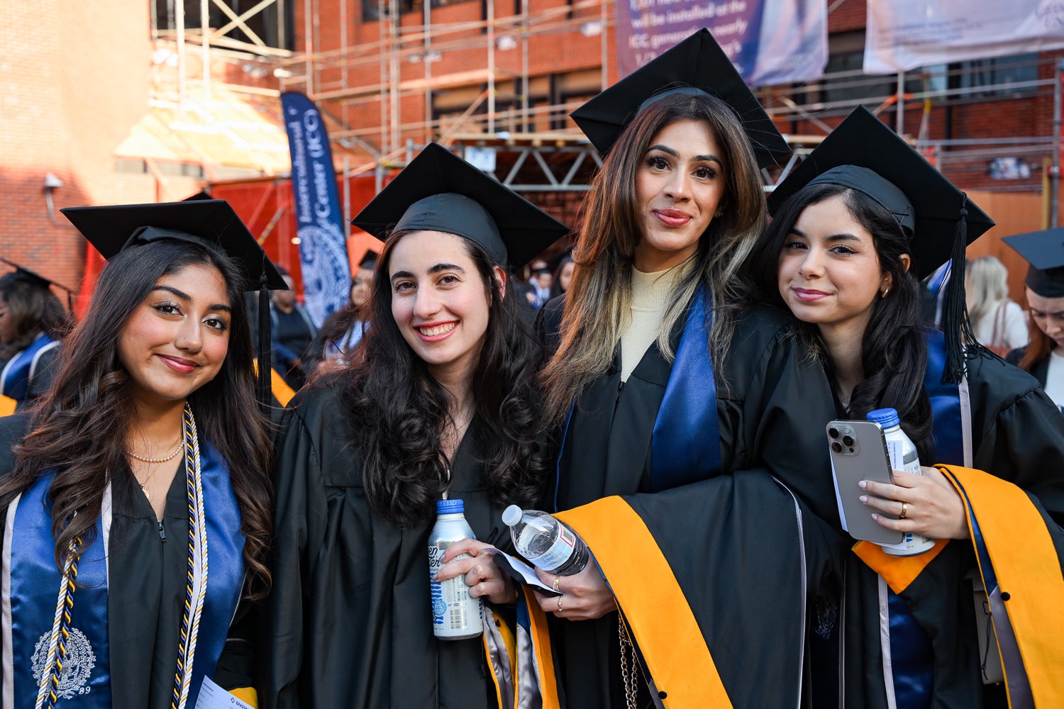 Graduates in commencement regalia pose together on Red Square before the ceremony