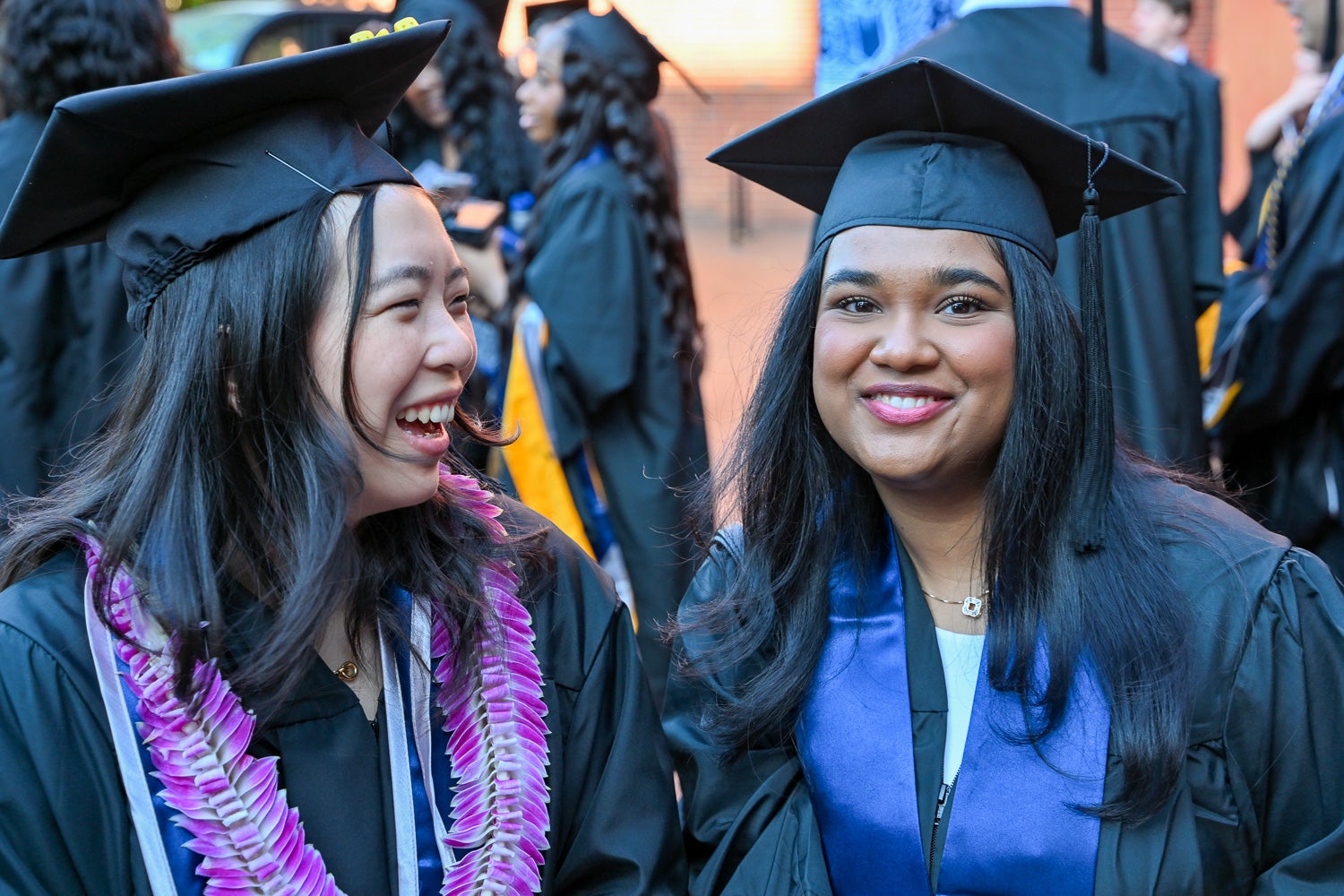 Graduates in commencement regalia pose together on Red Square before the ceremony