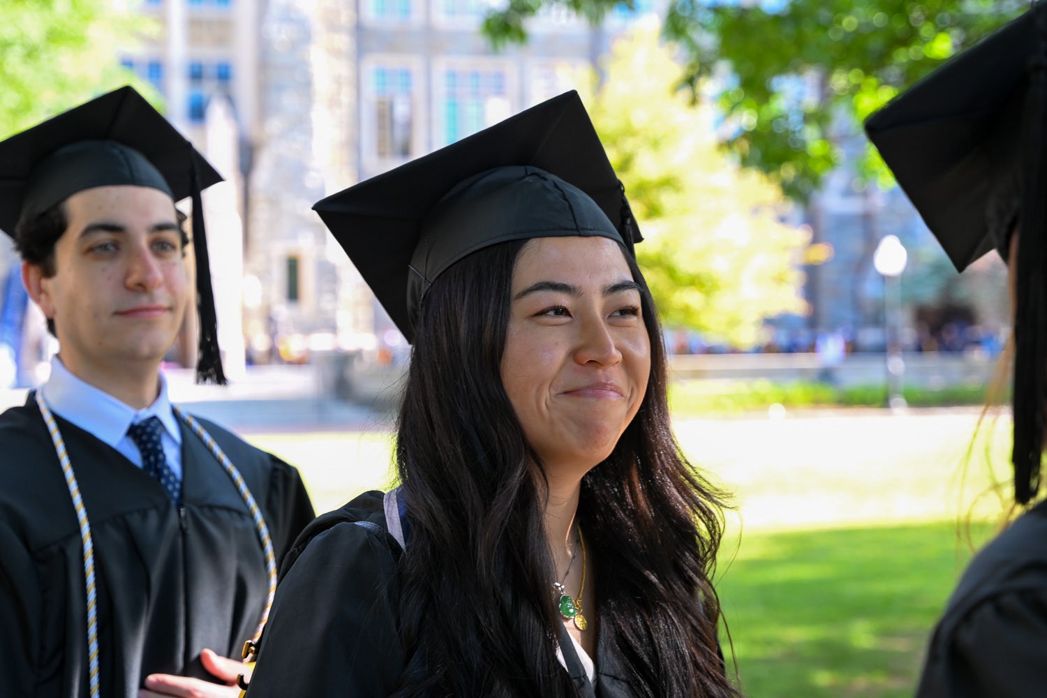 Graduates in commencement regalia process across Copley Lawn to the ceremony