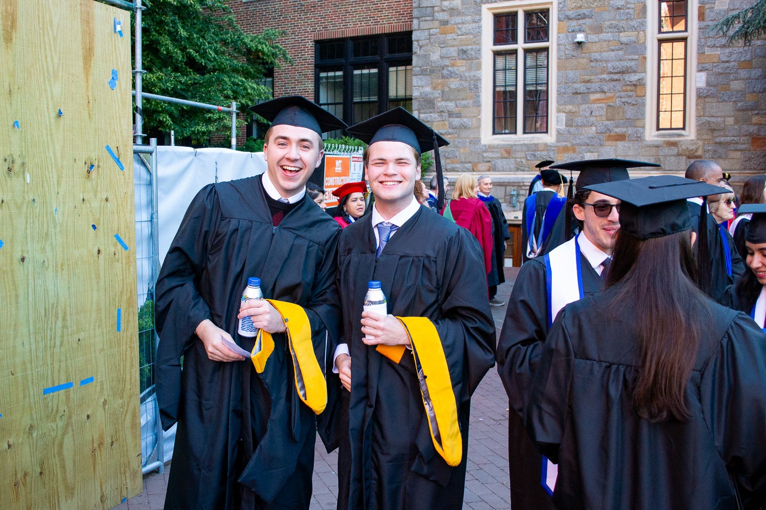 Graduates in commencement regalia pose together on Red Square before the ceremony