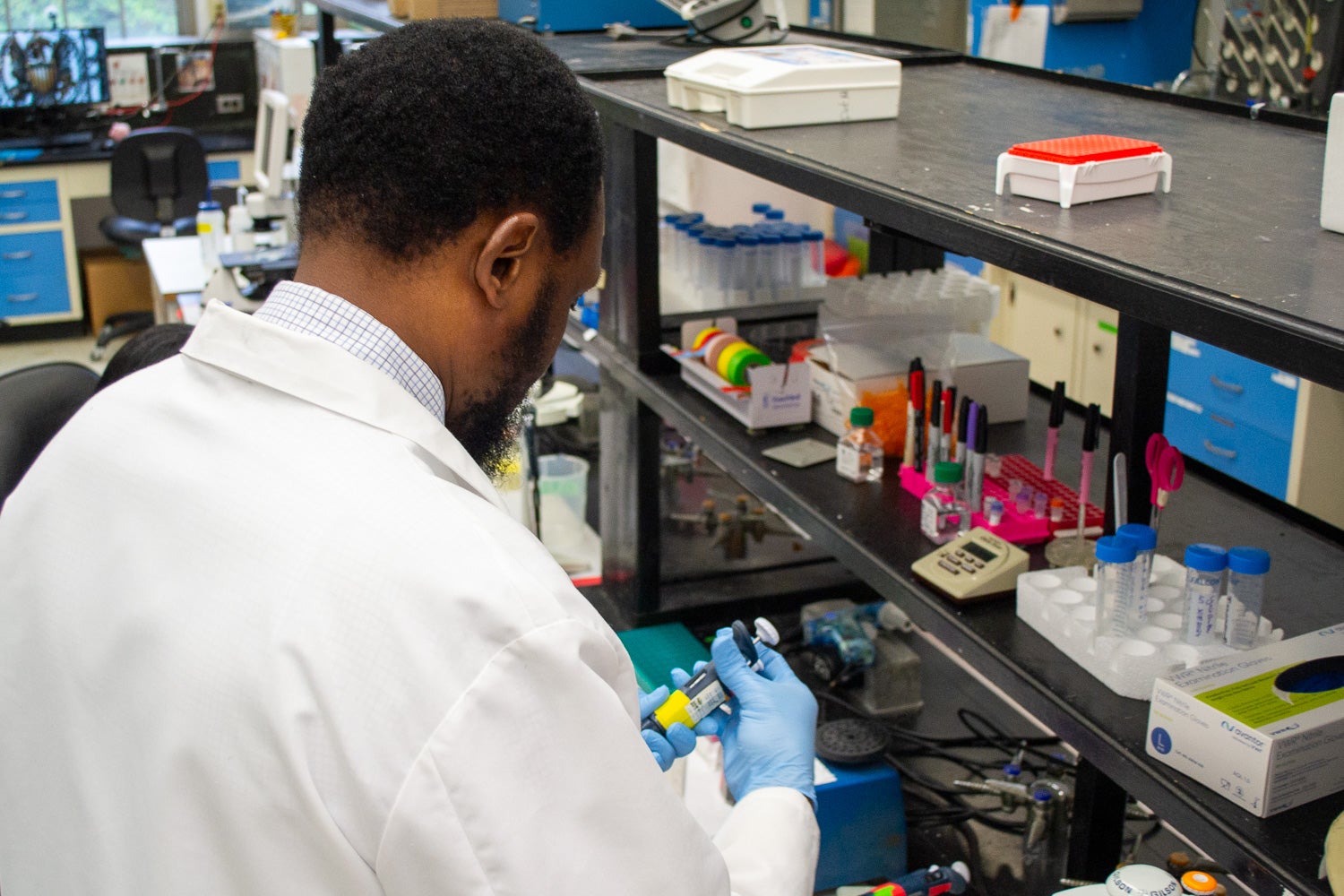 A student works with a pipette in a lab