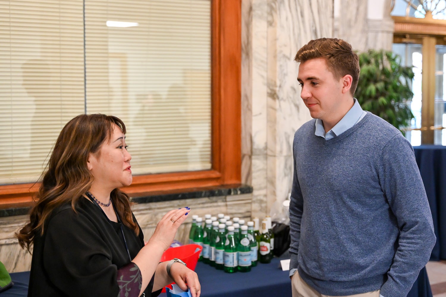 A student and professor talk at the Department of Microbiology & Immunology Reception