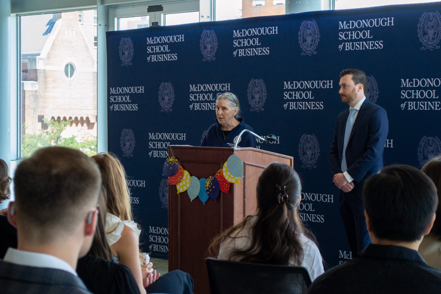 Kathy Maguire-Zeiss speaks at the podium at Neuroscience Student Research Day