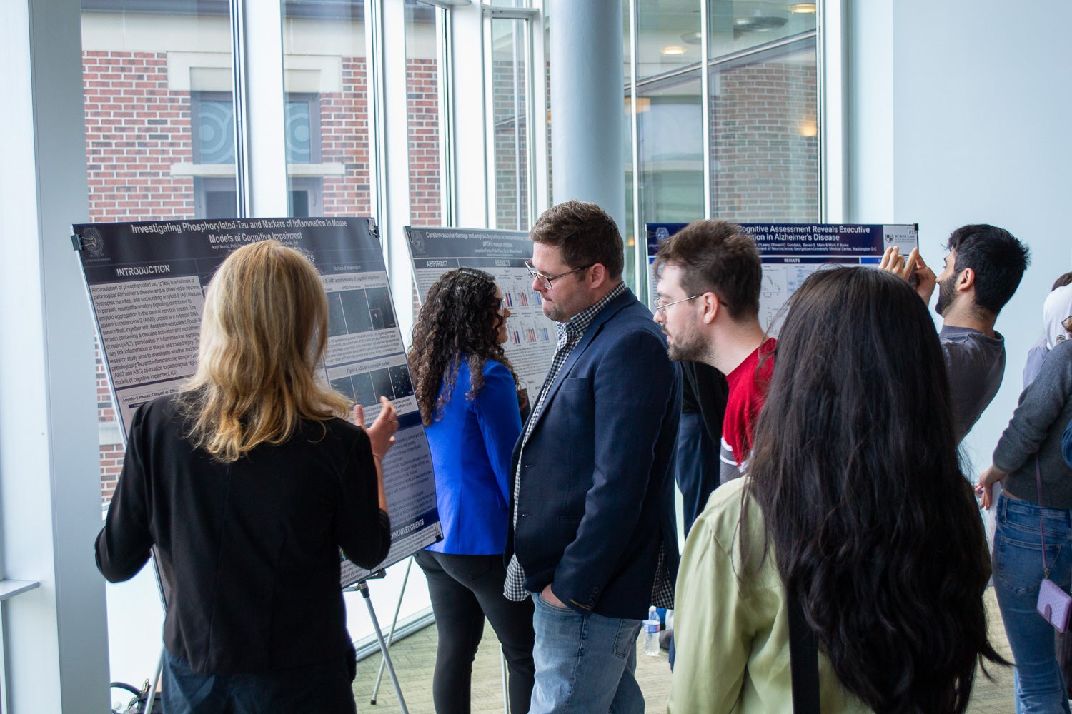 Attendees listen to poster presentations at Neuroscience Student Research Day