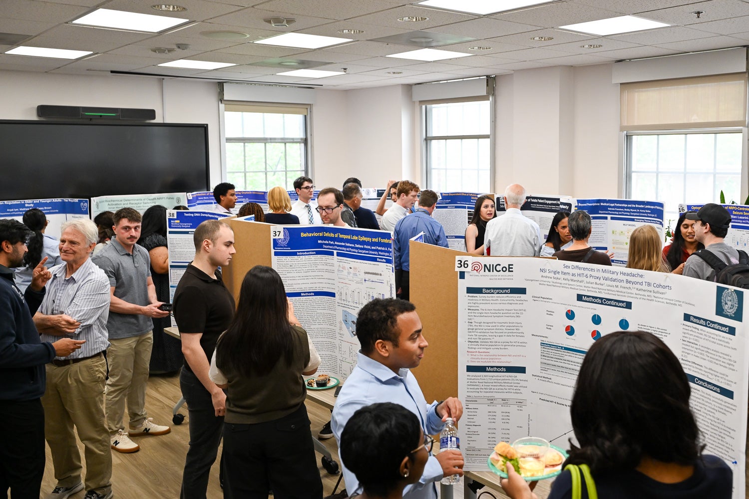 Attendees listen to presentations at Pharmacology & Physiology Poster Day