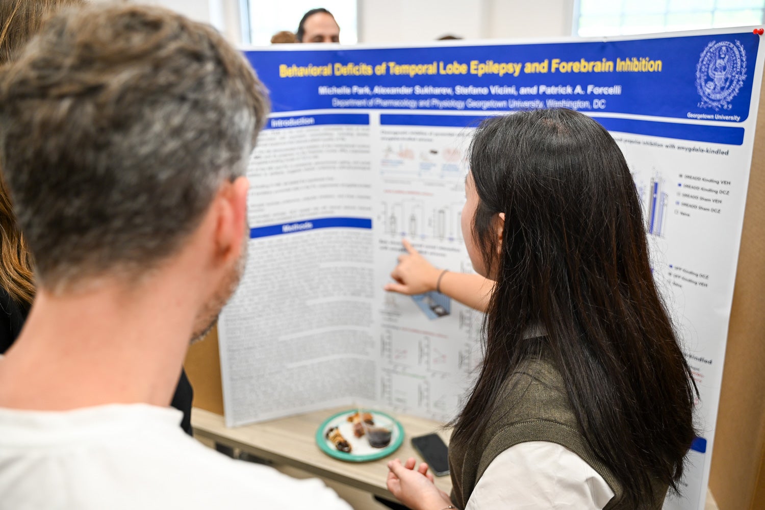 A student presents research at Pharmacology & Physiology Poster Day