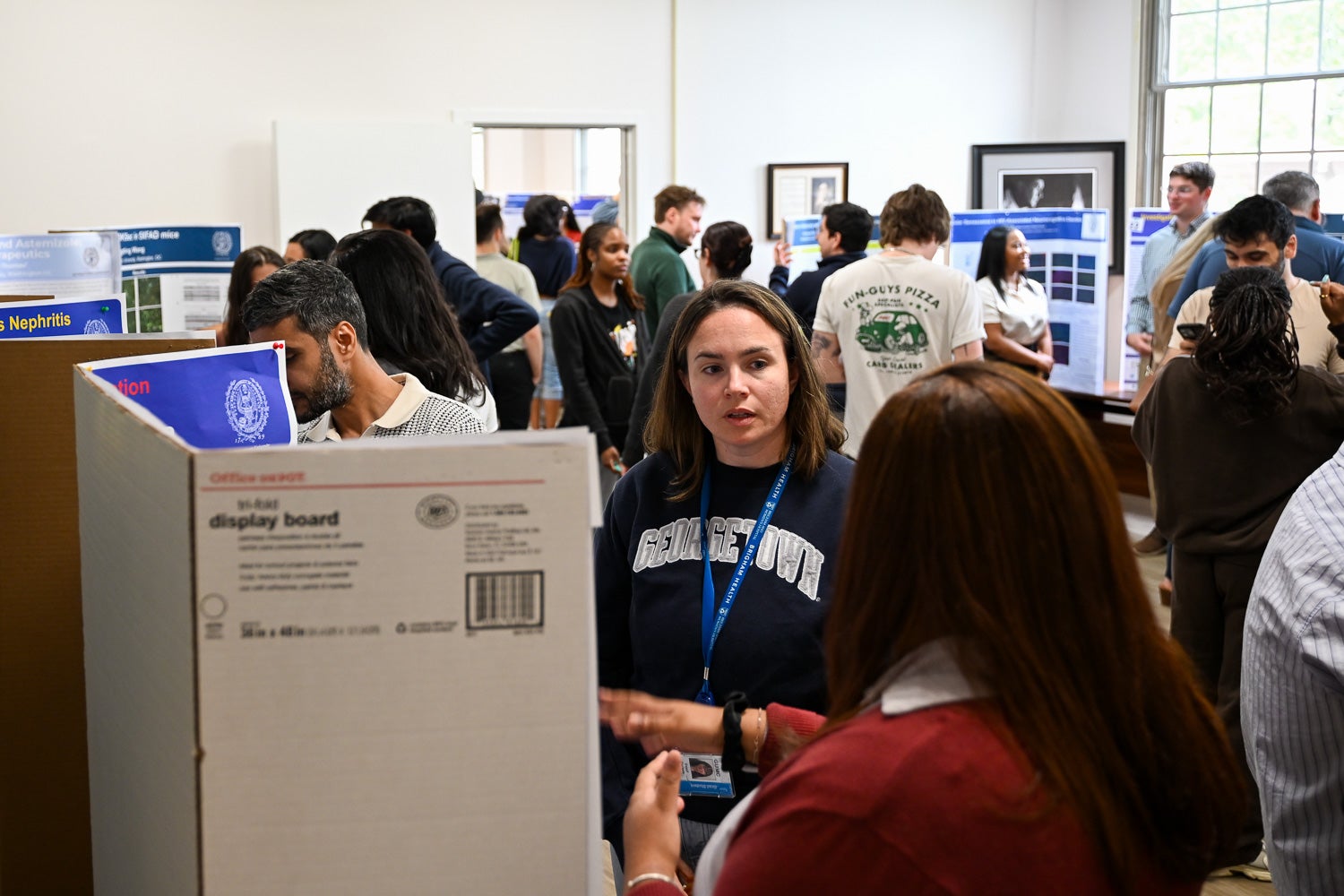 An attendee listens to presentations at Pharmacology & Physiology Poster Day